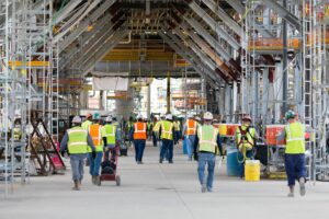 Construction workers walk onto a jobsite at a major construction project. 